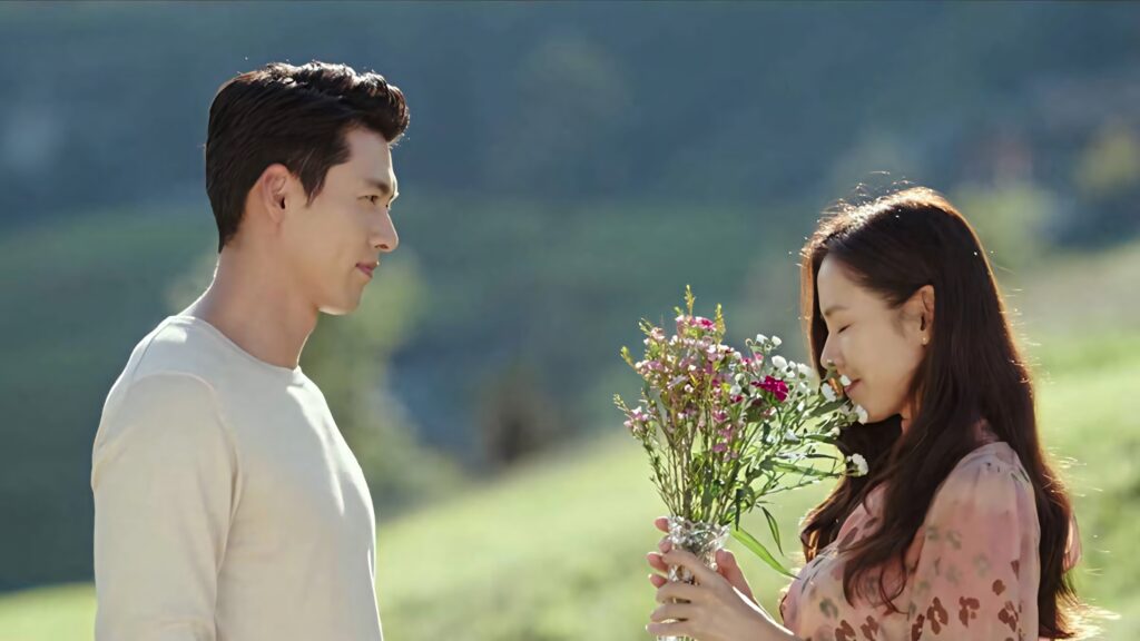 Crash Landing On You Yoon Se-ri Ri Jeong-hyeok romantic moment wildflowers sunlit outdoor wallpaper