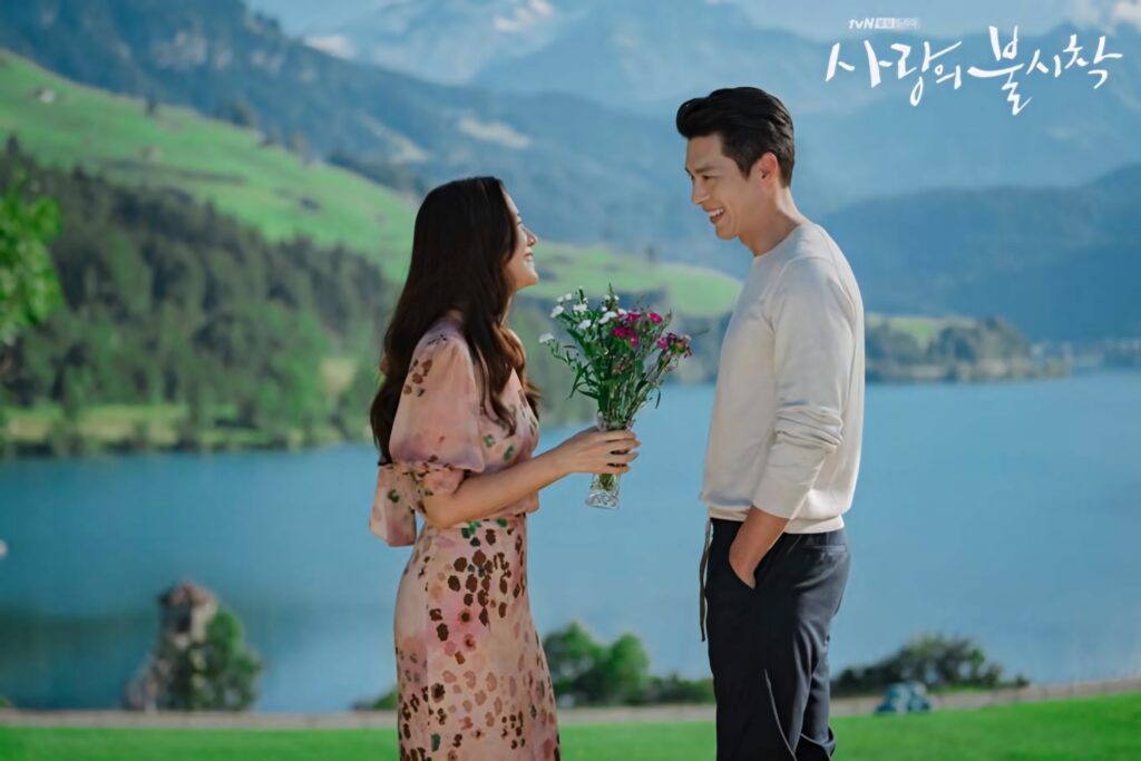 Yoon Se-ri and Ri Jeong-hyeok share a tender moment by lake with lush mountains Crash Landing On You Wallpaper