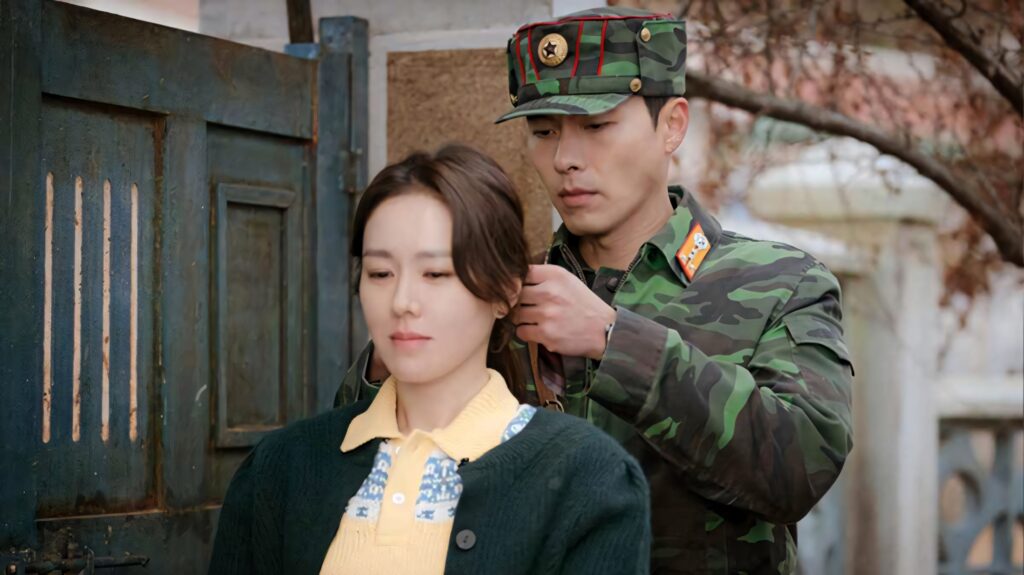 Yoon Se-ri and Ri Jeong-hyeok tender moment tying ponytail rustic background Crash Landing on You wallpaper