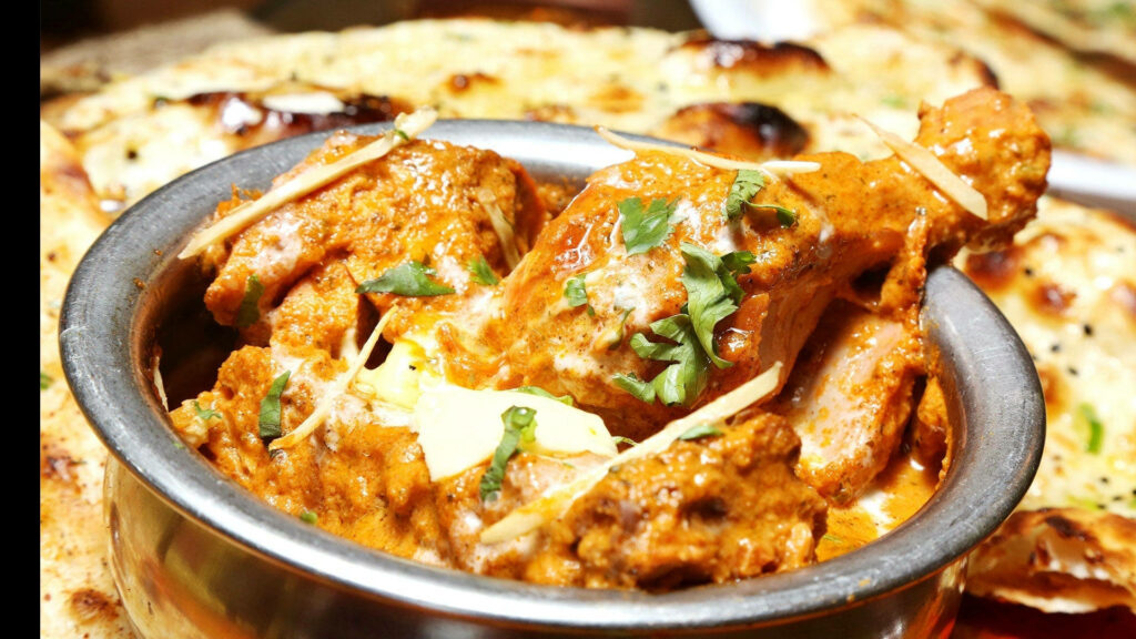Homemade butter chicken with creamy orange gravy cilantro ginger and oven baked naan wallpaper