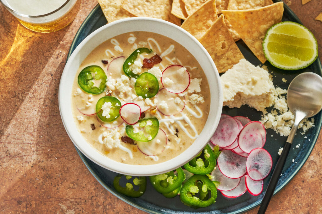 Creamy jalapeño chowder with fresh jalapeños radishes cheese tortilla chips and lime wedges Wallpaper