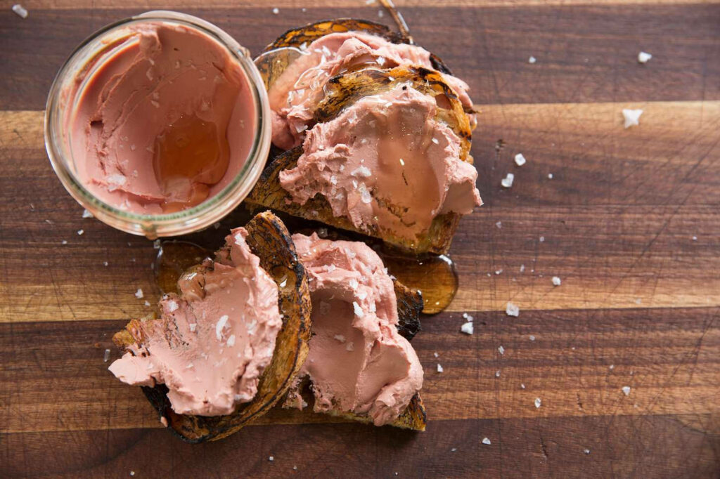 Creamy liver pate spread on toasted rustic bread with sea salt gourmet appetizer wallpaper