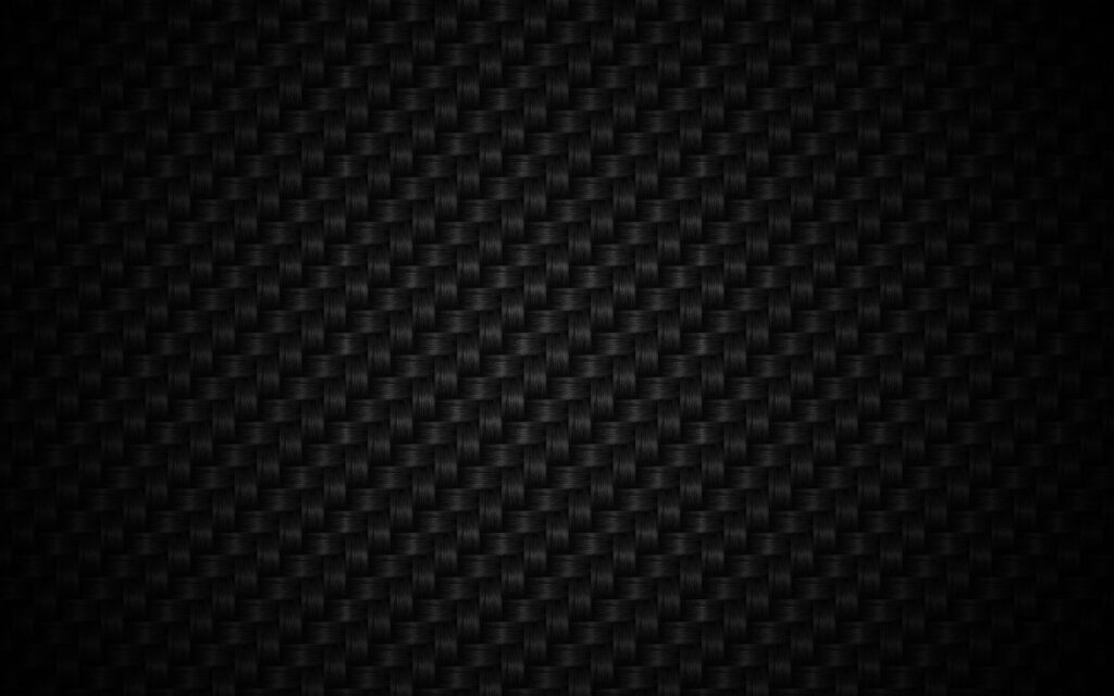 Black carbon fiber wallpaper with intricate woven texture and subtle vignette for QHD screens