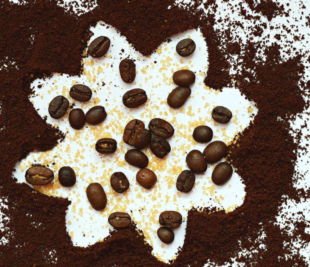 Artistic Coffee Wallpaper: Beans & Sugar on Ground Coffee Texture