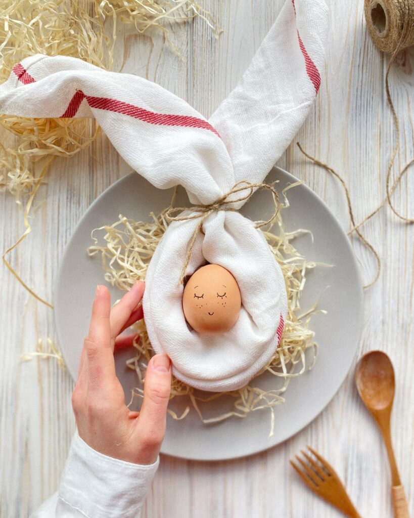 Whimsical Smiley Egg Wallpaper with Bunny Ears and Straw Nest