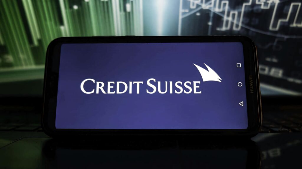 Credit Suisse logo on smartphone with blue background abstract financial charts green tones wallpaper