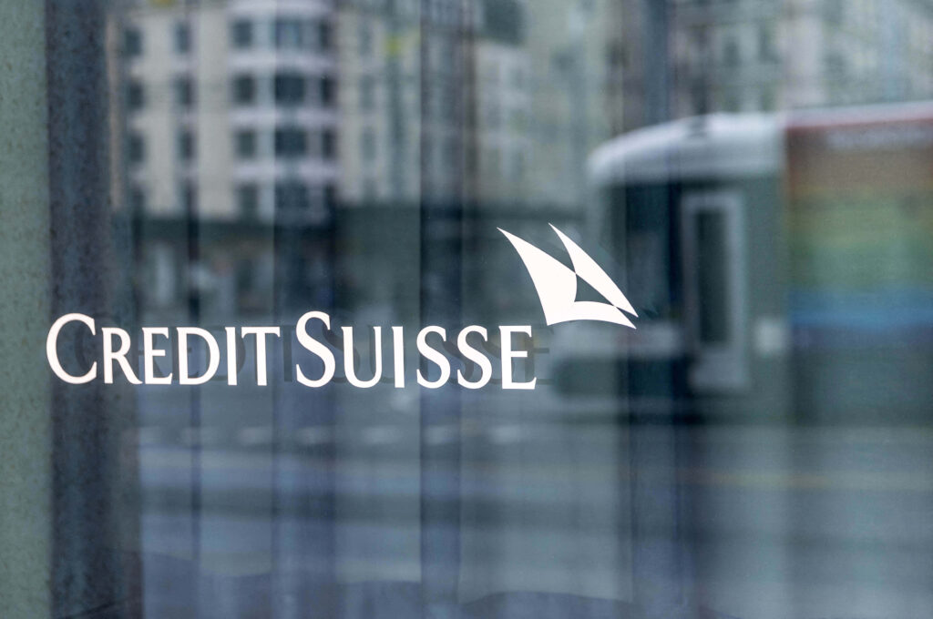 Credit Suisse wallpaper with white sailboat logo bold text on reflective glass urban city background