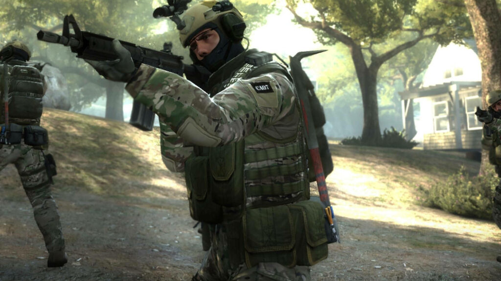 Stealthily Engaged: CSGO Operative Sneaking through Forest Terrain Wallpaper
