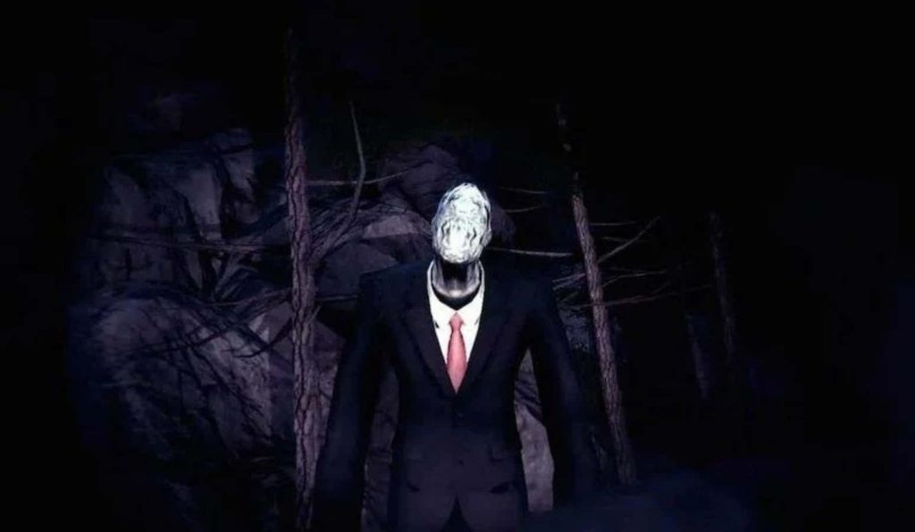 Slender Man in black suit and red tie ominous haunting dark forest flashlight beam wallpaper
