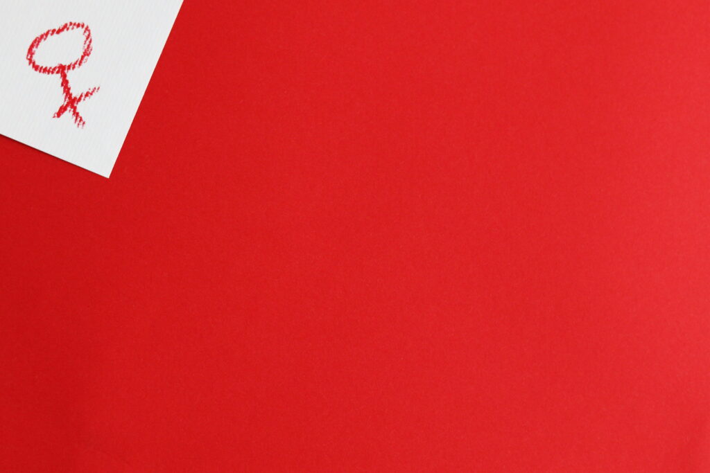 Vivid Contrast: Stunning Red Paper against a Clean White Table - Striking 4K Wallpaper Background Photograph