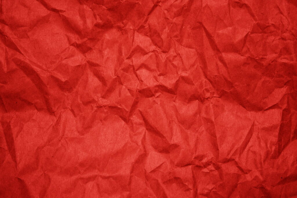 Vibrant Crimson Creases: 4K Wallpaper with Red Wrinkled Paper Texture