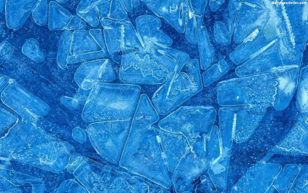 Macro close-up of fractured blue ice crystals with geometric shards for cool wallpaper background