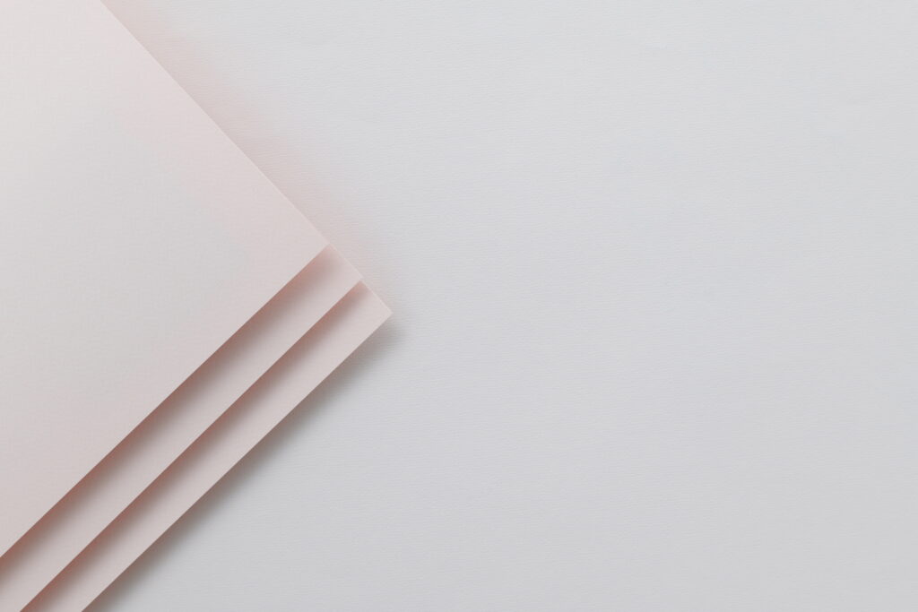 Minimalistic Elegance: 8K Wallpaper featuring White Paper on a White Table