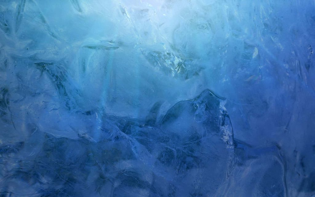Macro photo of blue glacial ice with crystalline textures and deep azure tones wallpaper background