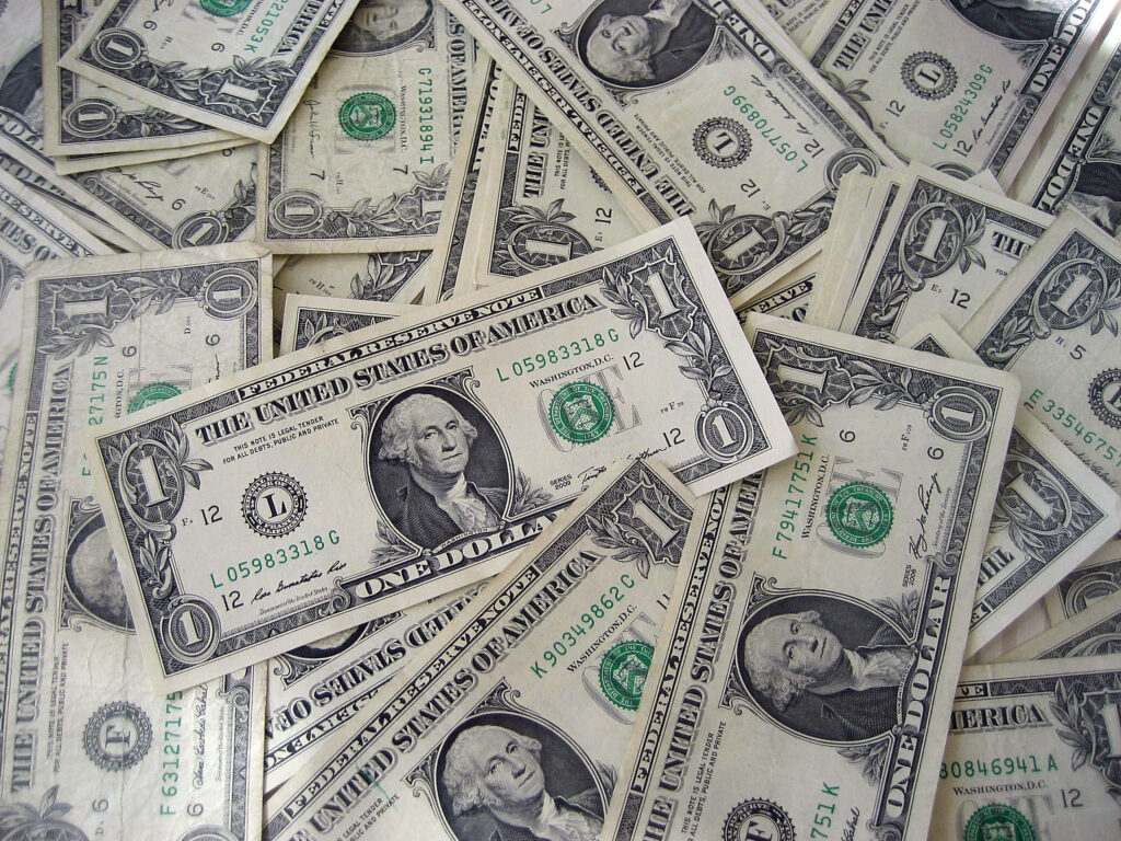 Scattered one dollar bills featuring George Washington and classic US currency design elements background Wallpaper