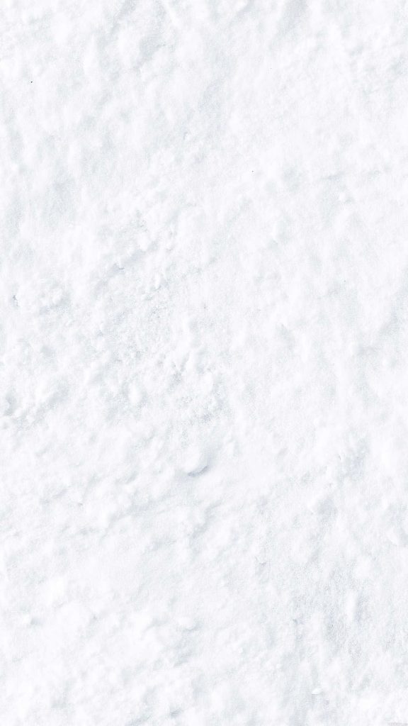 Macro close-up of granular powdery snow in bright white for minimalist winter wallpaper background