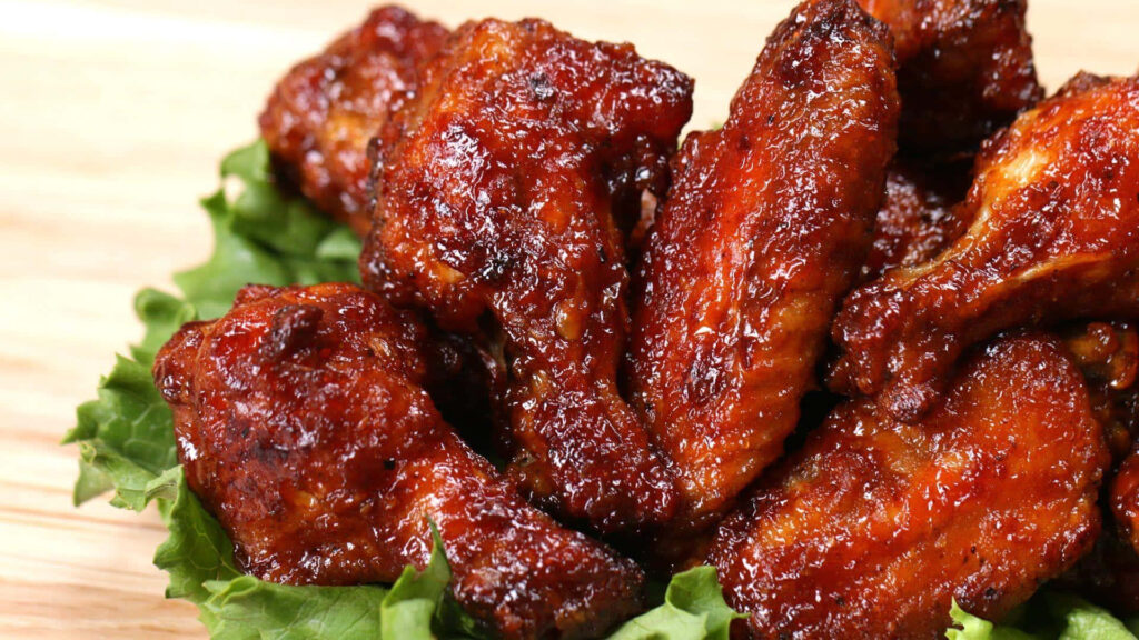 Crispy Glazed Chicken Wings on Lettuce - Appetizing Wallpaper