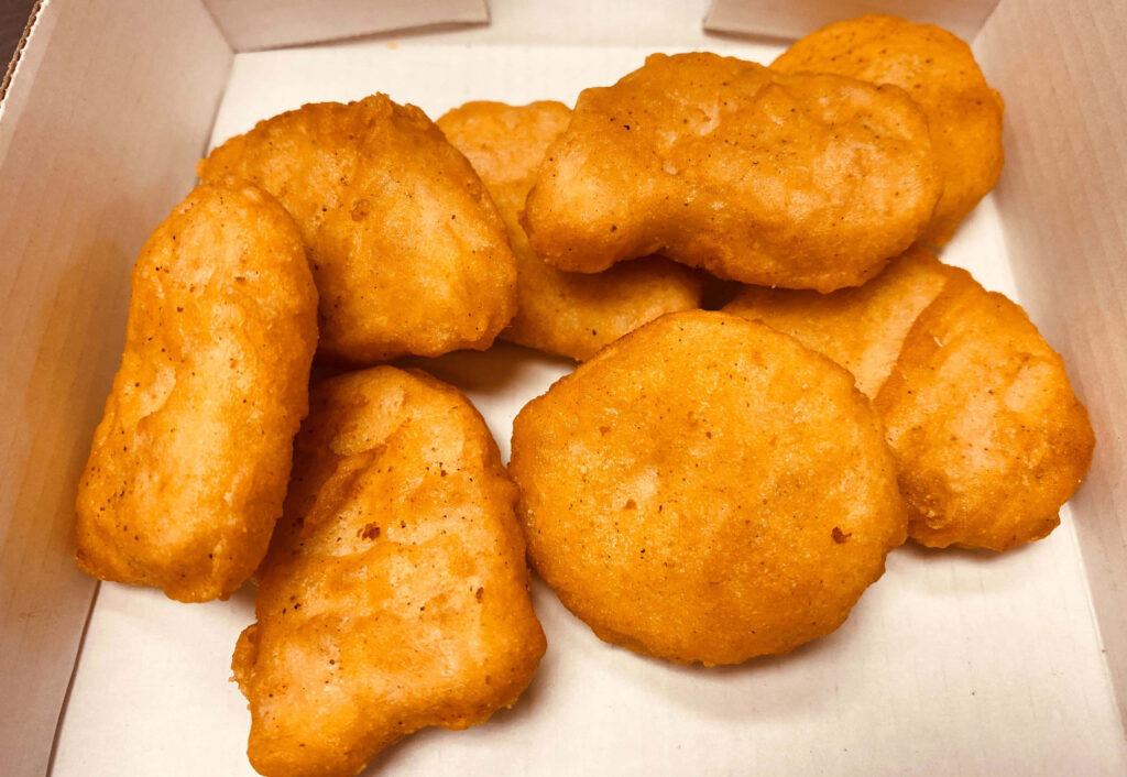 Crispy Golden-Brown Chicken Nuggets in a Box - Appetizing Wallpaper