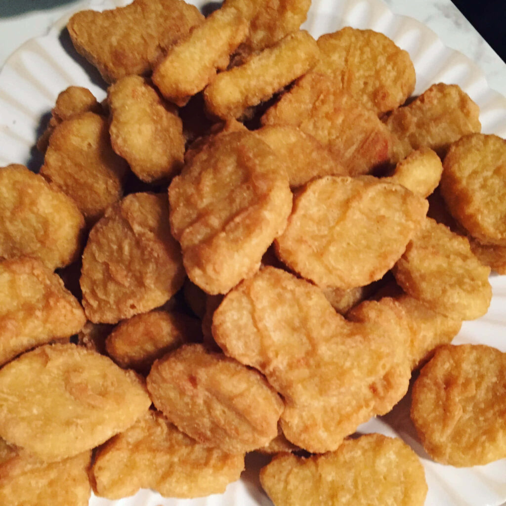 Crispy Golden Chicken Nuggets - Delicious Close-Up Wallpaper Background