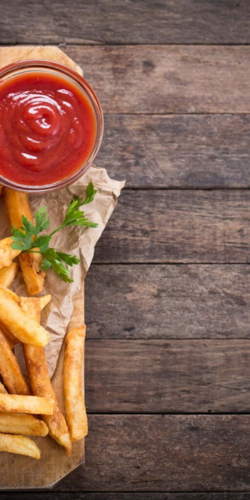Crispy Golden Fries with Ketchup on Rustic Wood - Wallpaper Background