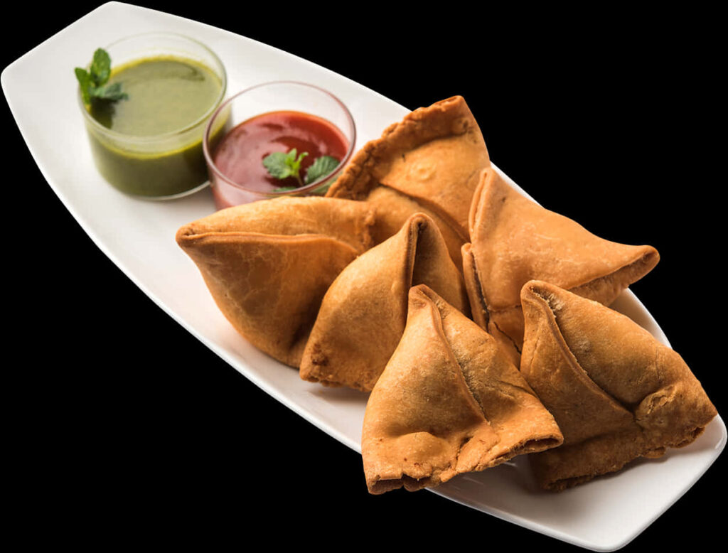 Delicious Samosas with Chutney and Sauce - Tasty Snack Wallpaper