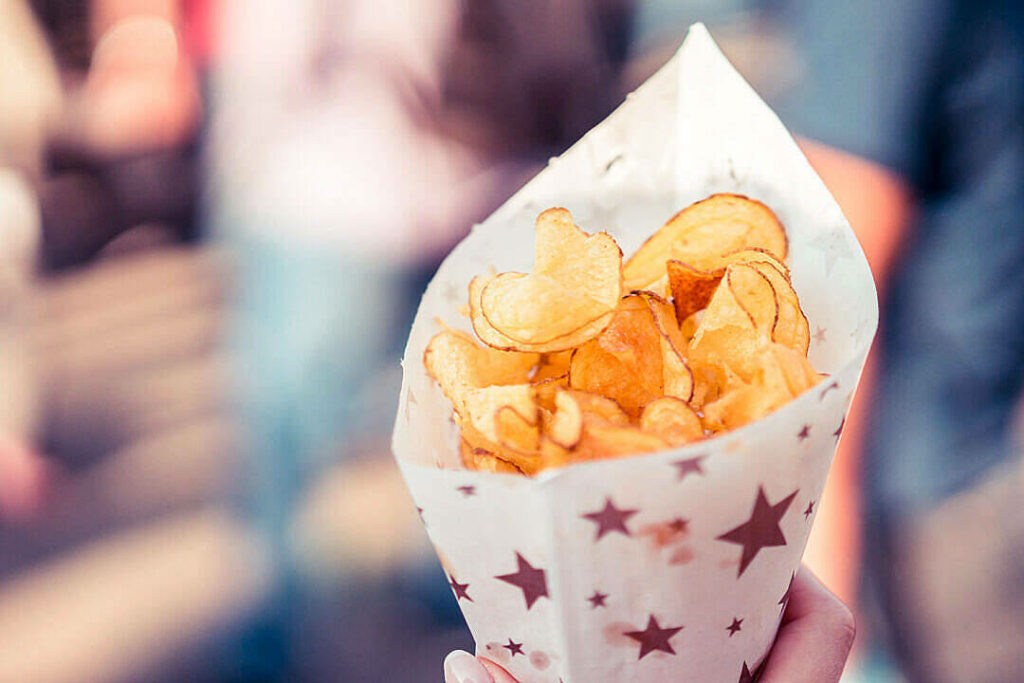 Crispy Potato Chips in Decorative Cornet - Food Wallpaper Background