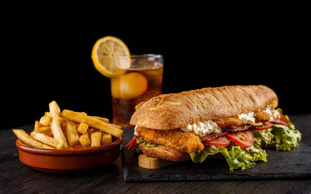 Crispy Submarine Sandwich Wallpaper with Fries & Drink Background