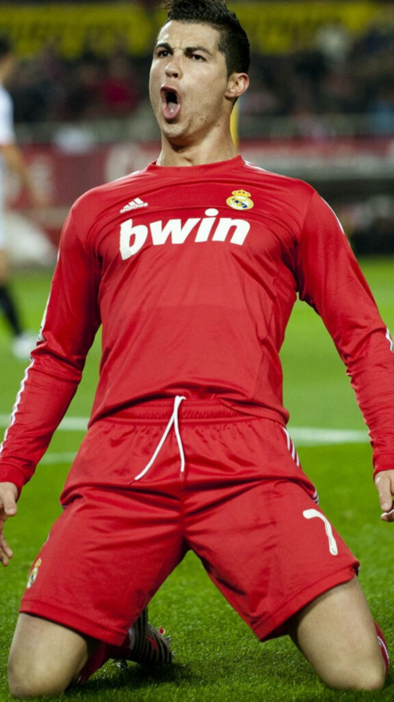 Dynamic Cristiano Ronaldo Wallpaper: Iconic Celebration in Red Kit