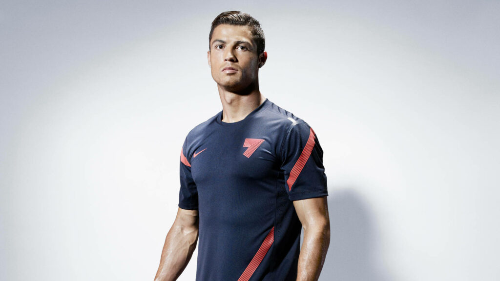Cristiano Ronaldo in navy Nike shirt with red accents studio portrait HD sports wallpaper