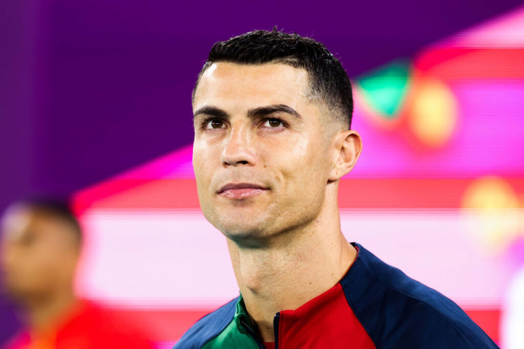 Cristiano Ronaldo Wallpaper: Focused & Determined on Vibrant Background