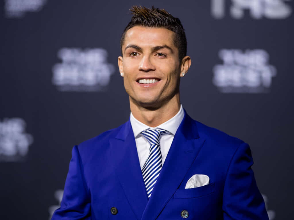 Vibrant Blue Suit Wallpaper: Cristiano Ronaldo’s Charismatic Presence