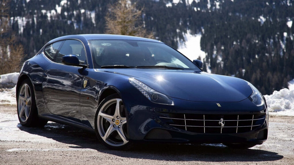 Unleashing Elegance and Domination: A Striking Black Ferrari FF Enveloped by Majestic Snow-Capped Peaks and Endless Skies Wallpaper