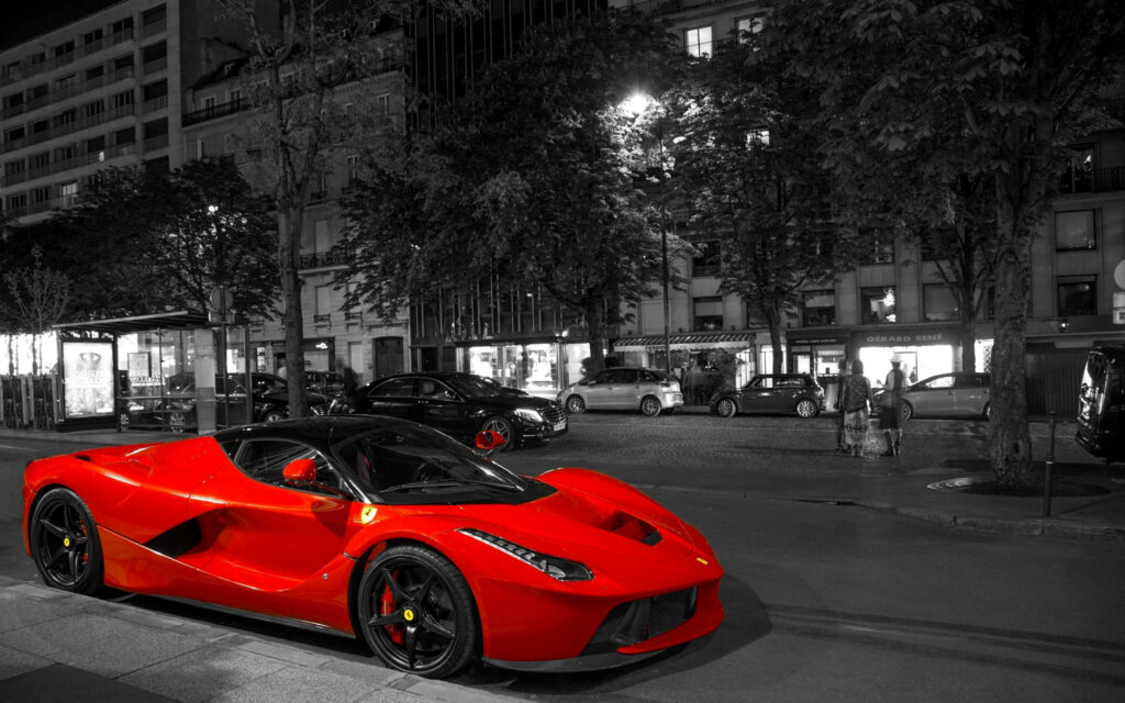 Street Racing Vibes: Red Hot Car Accentuates Dynamic Monochrome Street Scenery Wallpaper