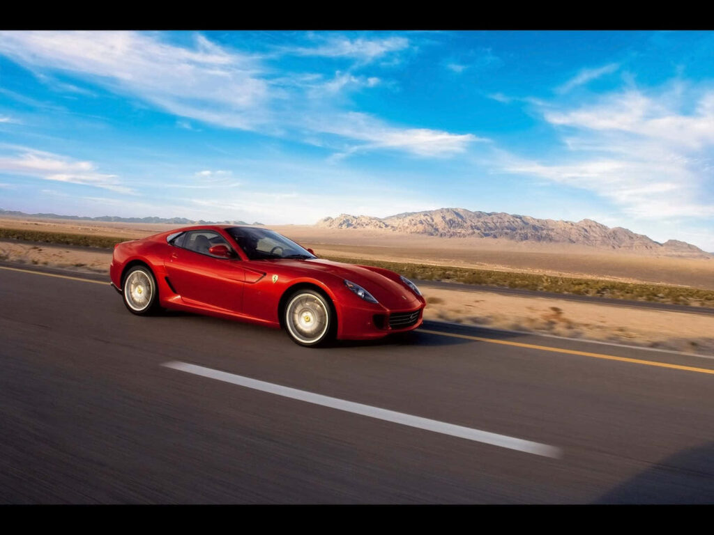 Exquisite Italian Power: Captivating the Open Road with the Red Ferrari 599 GTB Fiorano Wallpaper
