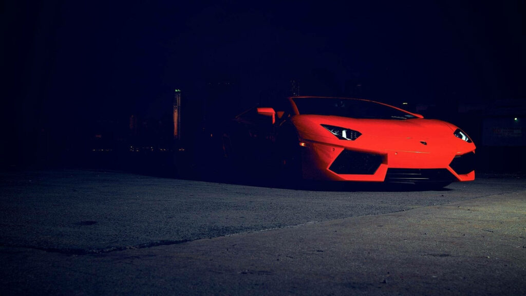 Roaring Speed in the Shadows: Captivating Red Sports Car in a Mysterious Setting - Cool Desktop Background Photo Wallpaper