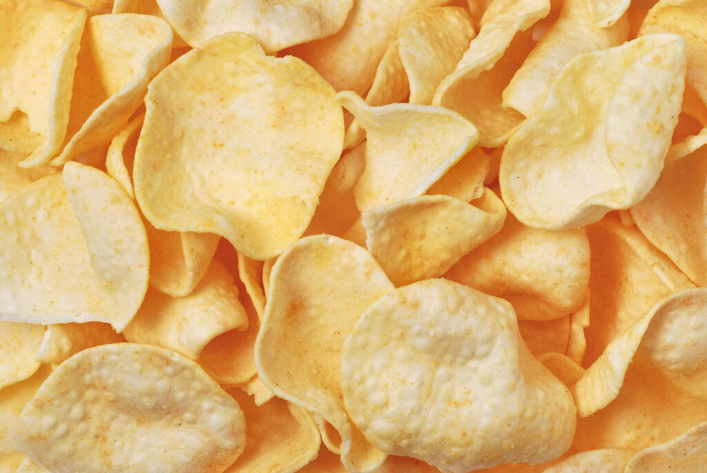 Golden Crispy Potato Chips Close-Up Wallpaper Background