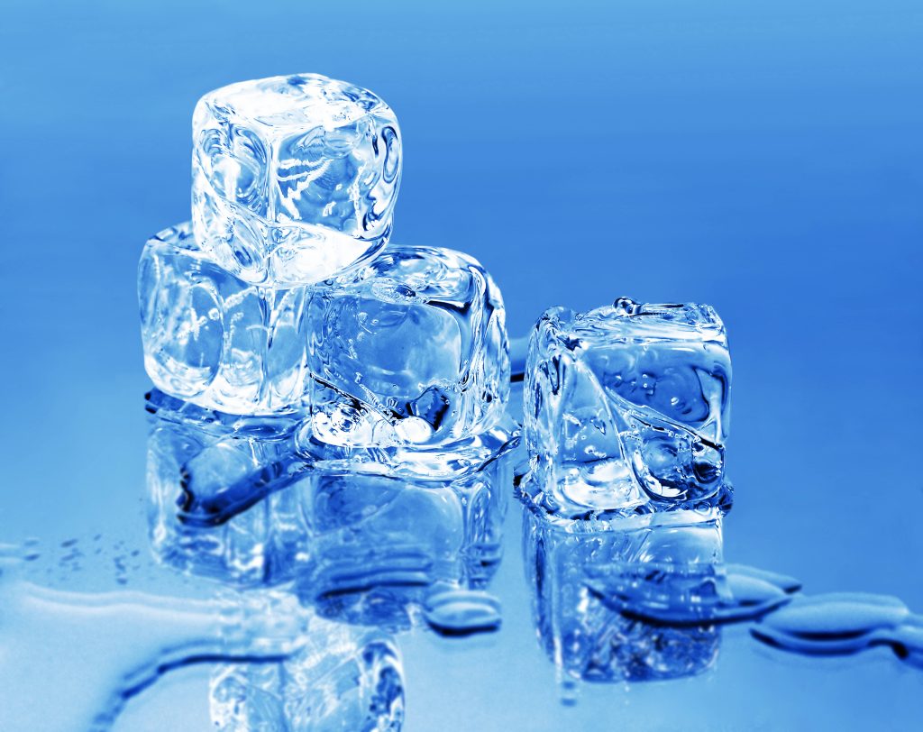 Crisp macro wallpaper of clear ice cubes and water droplets on reflective blue surface background