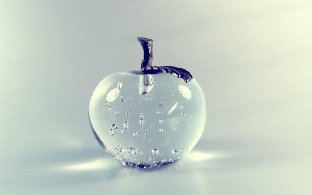 Crystal Clear Delight: Macro Shot of Transparent Glass Apple as QHD Wallpaper Background Photo