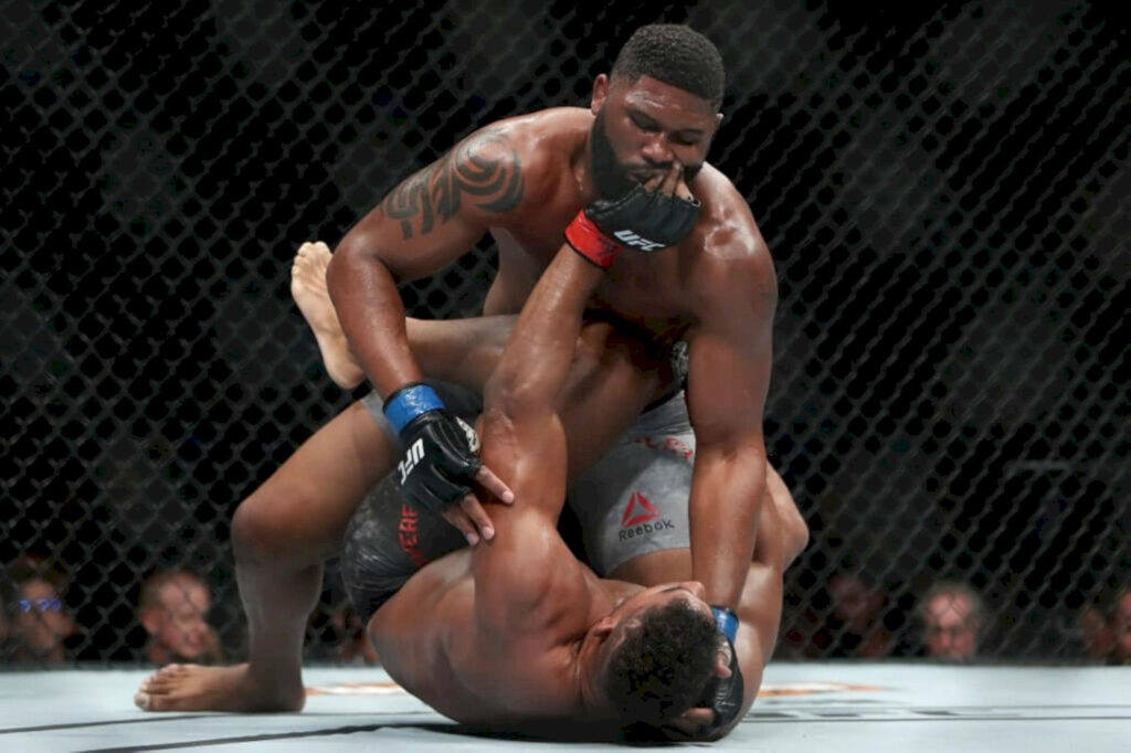 Curtis Blaydes intense MMA ground and pound action inside octagon dynamic athletic wallpaper