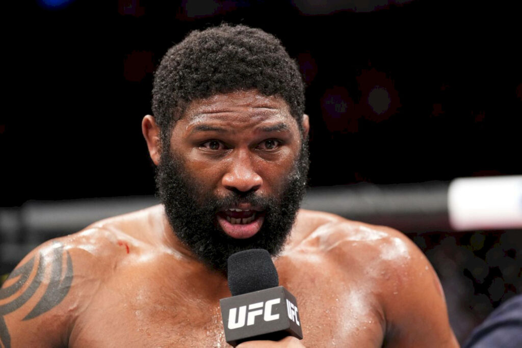 Curtis Blaydes in UFC octagon delivering intense post-fight speech with focused expression Wallpaper