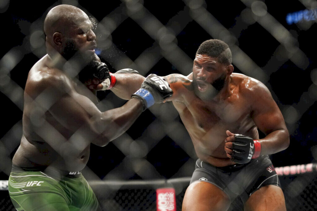 Curtis Blaydes lands a powerful UFC punch showing intense MMA action and athleticism in octagon Wallpaper