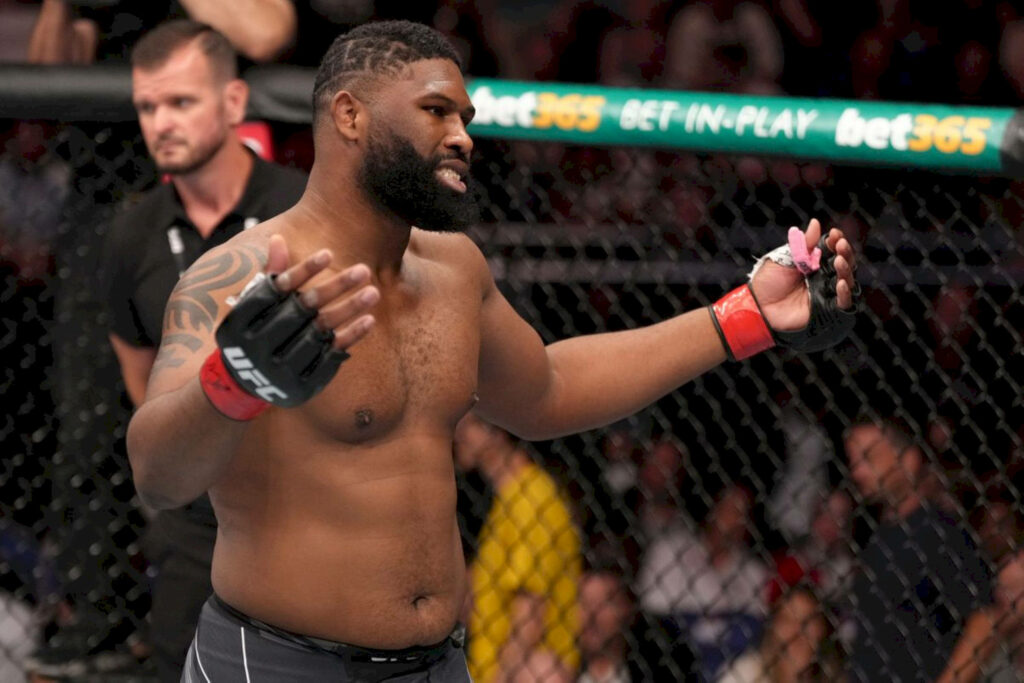 Curtis Blaydes frustrated in UFC octagon with arms raised intense MMA fight atmosphere wallpaper