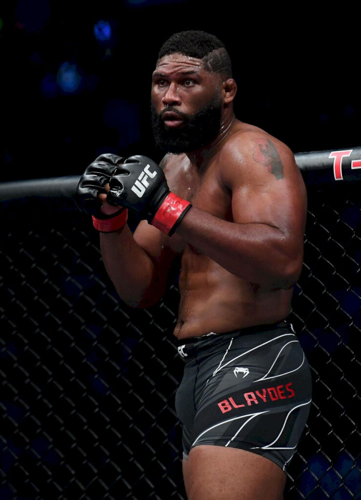 Curtis Blaydes in UFC gear inside octagon focused intense lighting athletic physique wallpaper