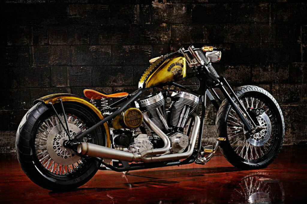 Golden Brass Balls Cycles Chopper Wallpaper: Intricate Industrial Design