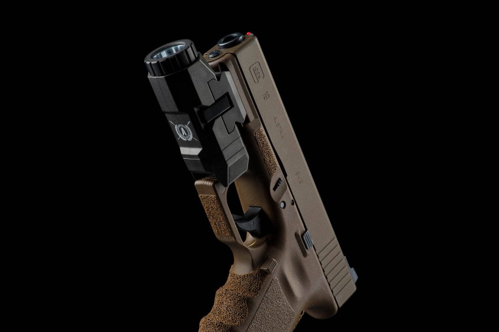 High resolution studio wallpaper of custom Glock 19 copper cerakote with stippled grip and light