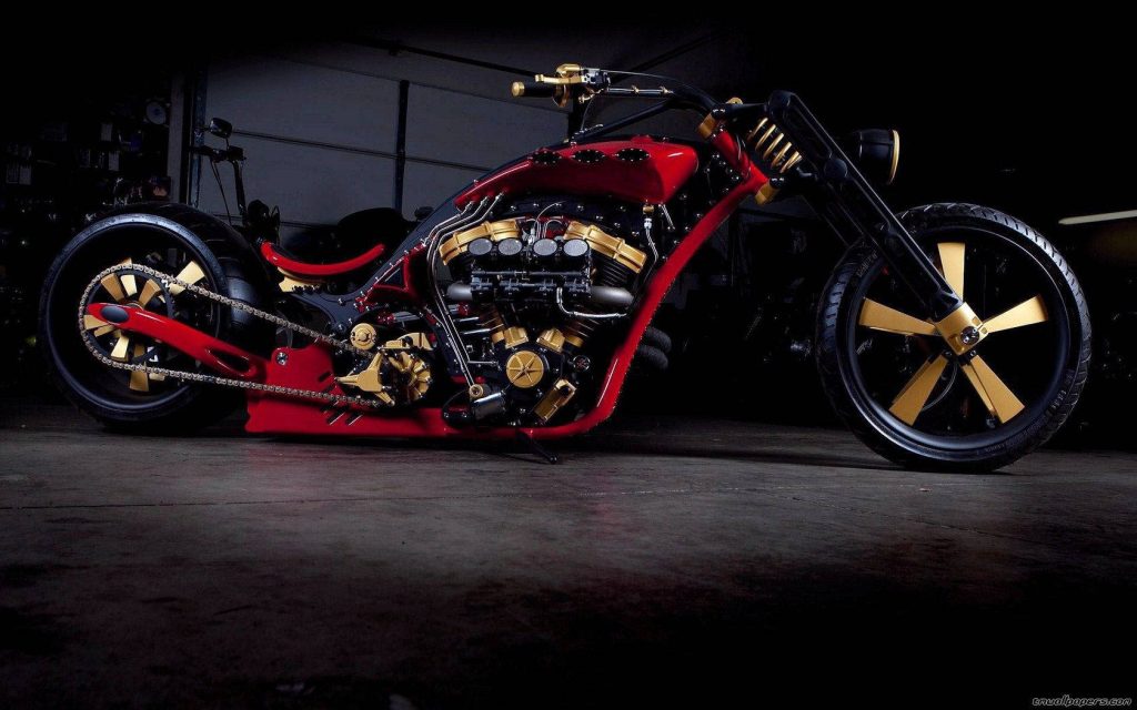 Custom chopper motorcycle metallic gold red V-twin engine custom wheels moody low-key lighting Wallpaper