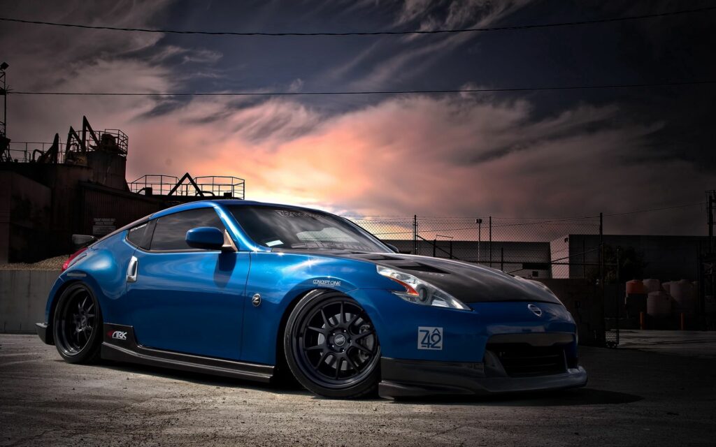 Sleek Blue Nissan 370Z Wallpaper: Custom Tuning in Dusk Industrial Setting