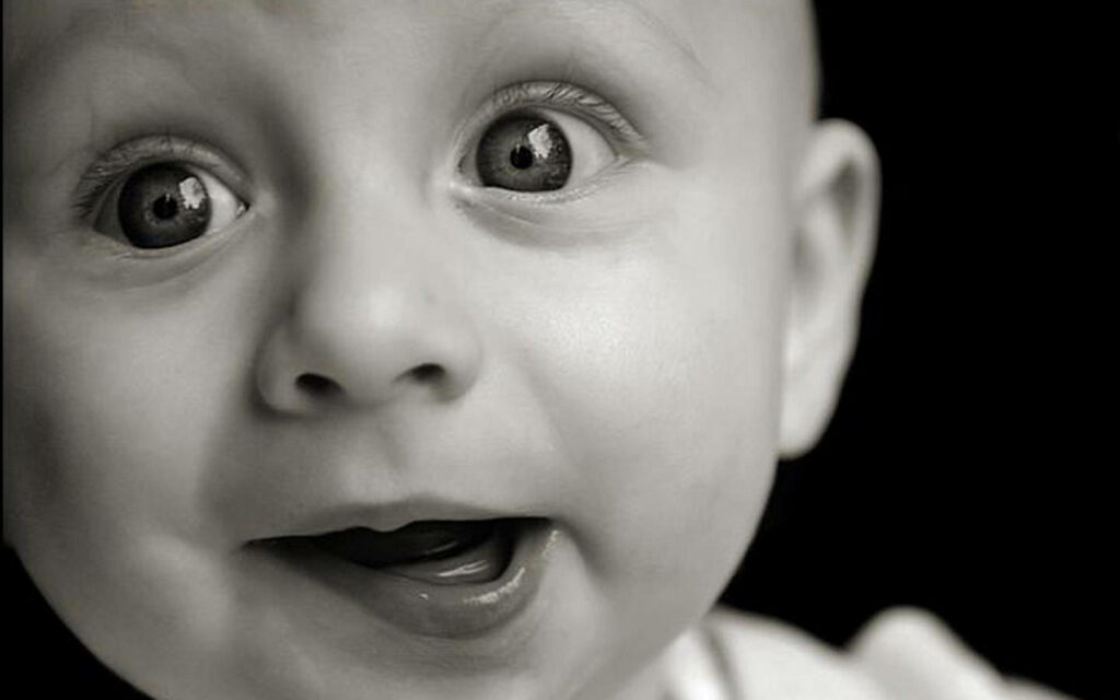 Joyful Baby Wallpaper: Cute B&W Aesthetic with Innocent Expression