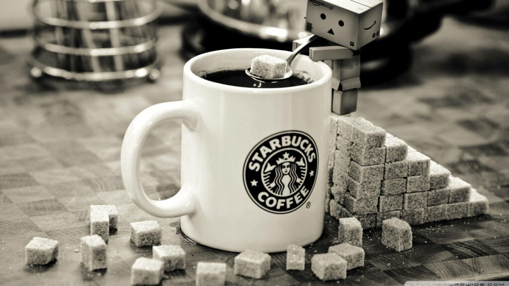 Cardboard robot balancing sugar cube on steaming Starbucks coffee with sugar cube pyramid background Wallpaper