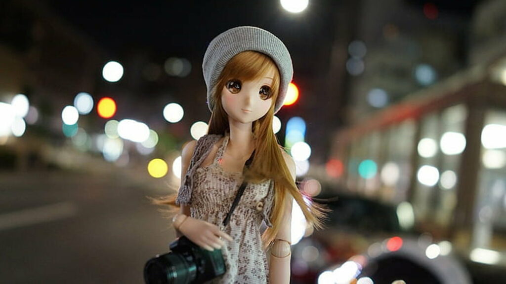 Stylish Smart Doll holding DSLR camera with colorful bokeh city night background wallpaper